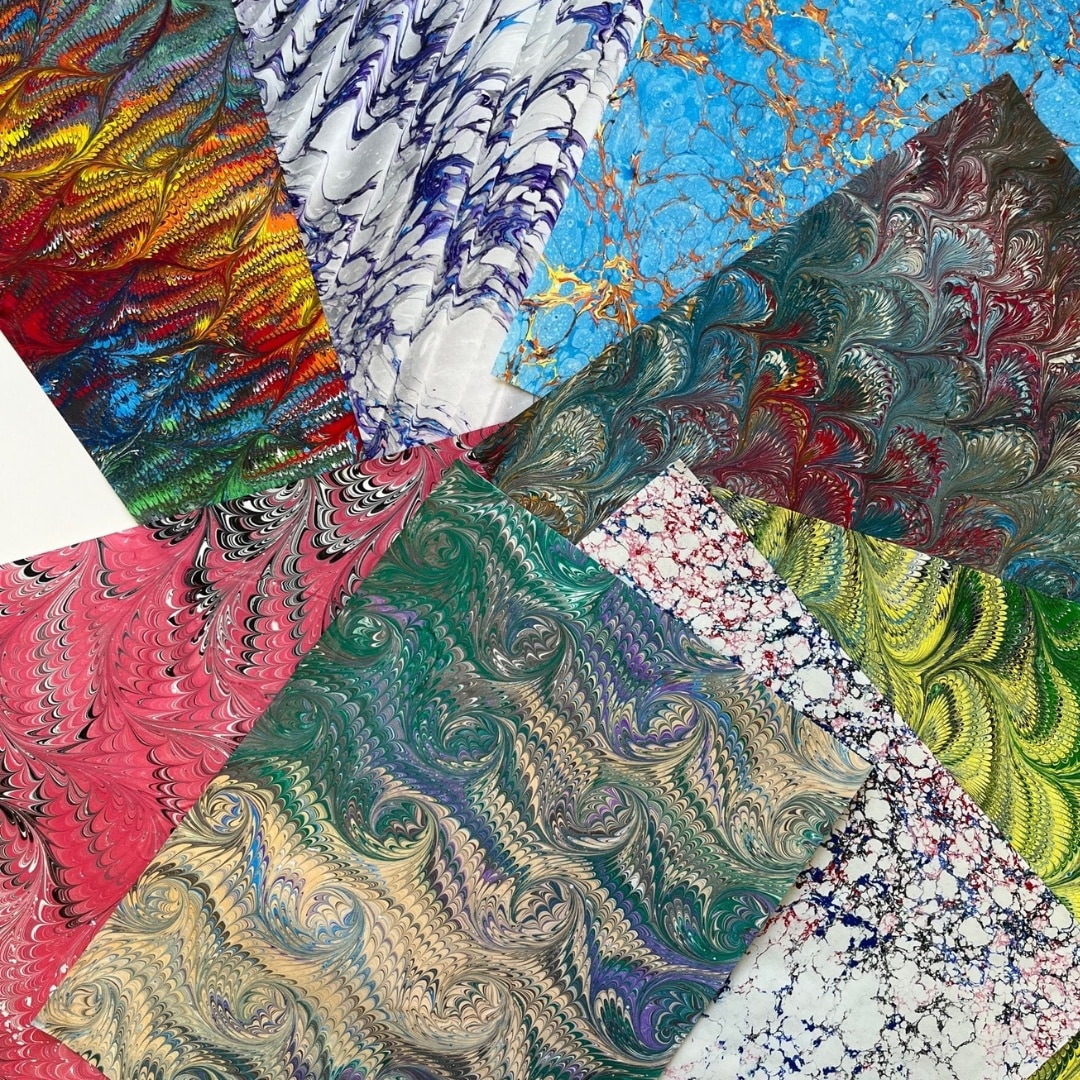 a fanned pile of wildly colorful marbled ebru papers