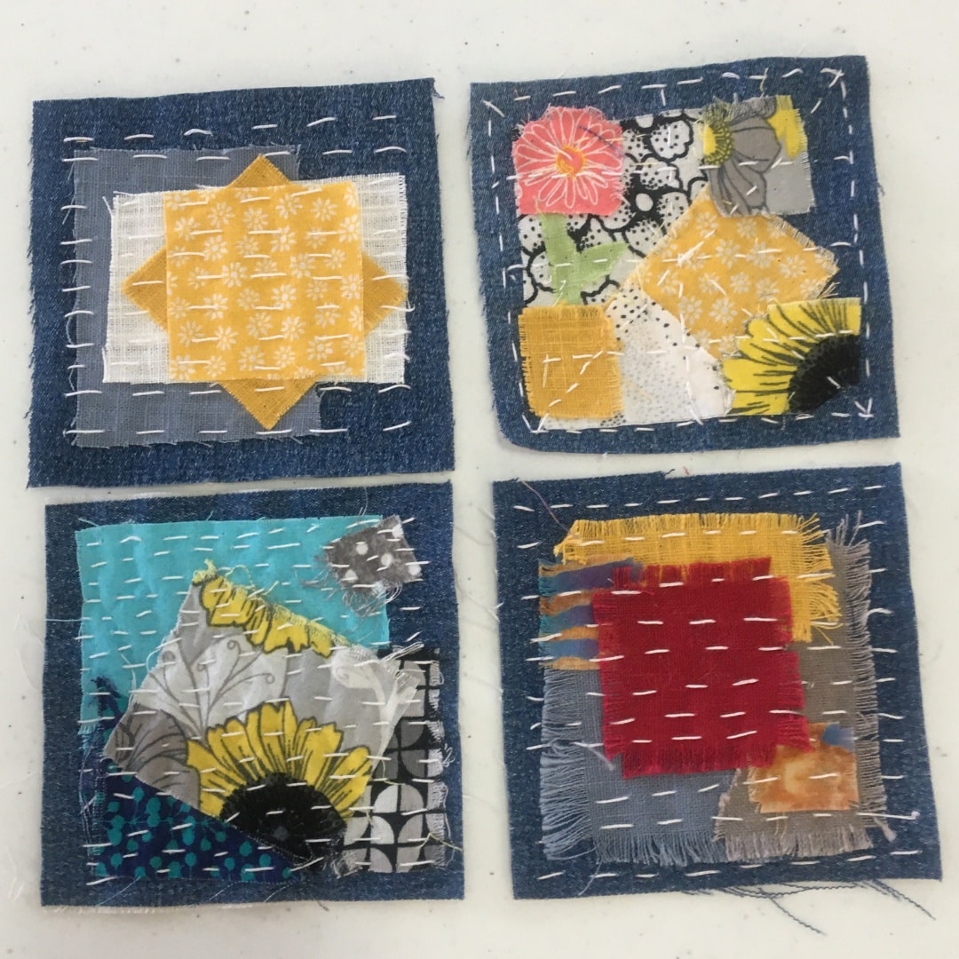 four panels of sashiko embroidery and fabric collage