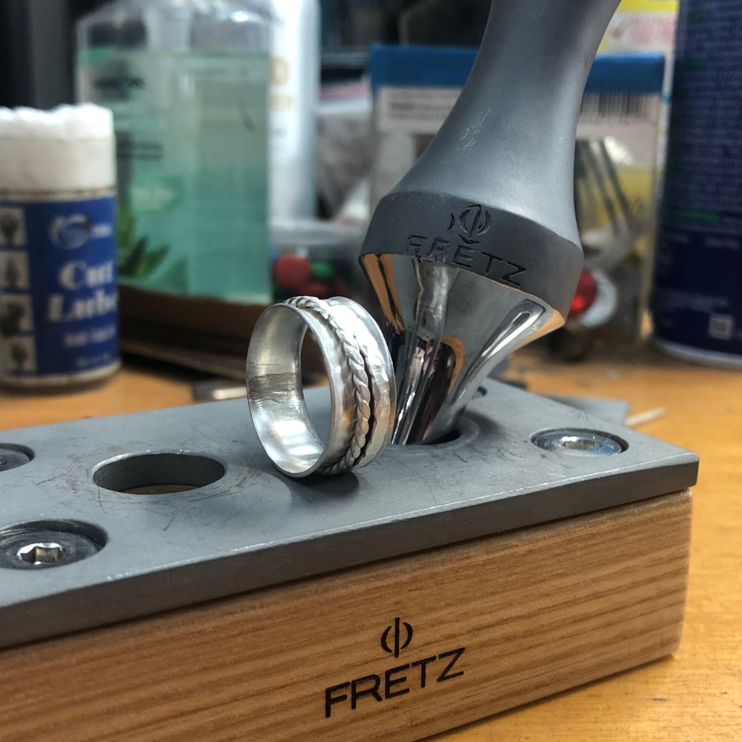 a spinner ring on a workbench with a soldering iron