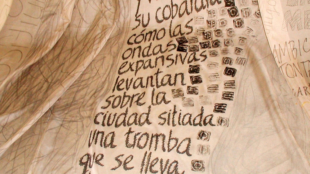 Spanish words sprawl in rows down a rough-textured paper.