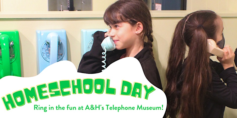 Two young girls speaking into the rotary phone in our Telephone Museum.