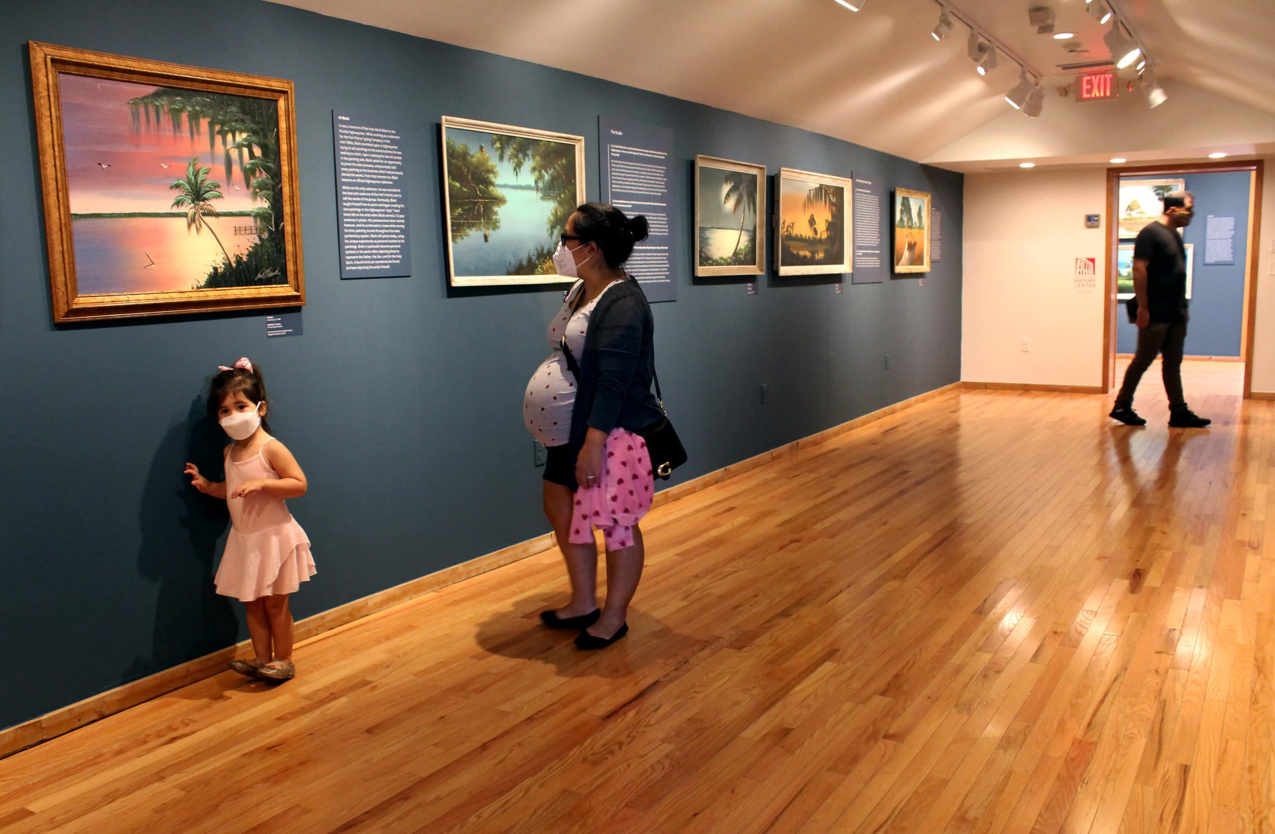 A latino family explores the gallery together
