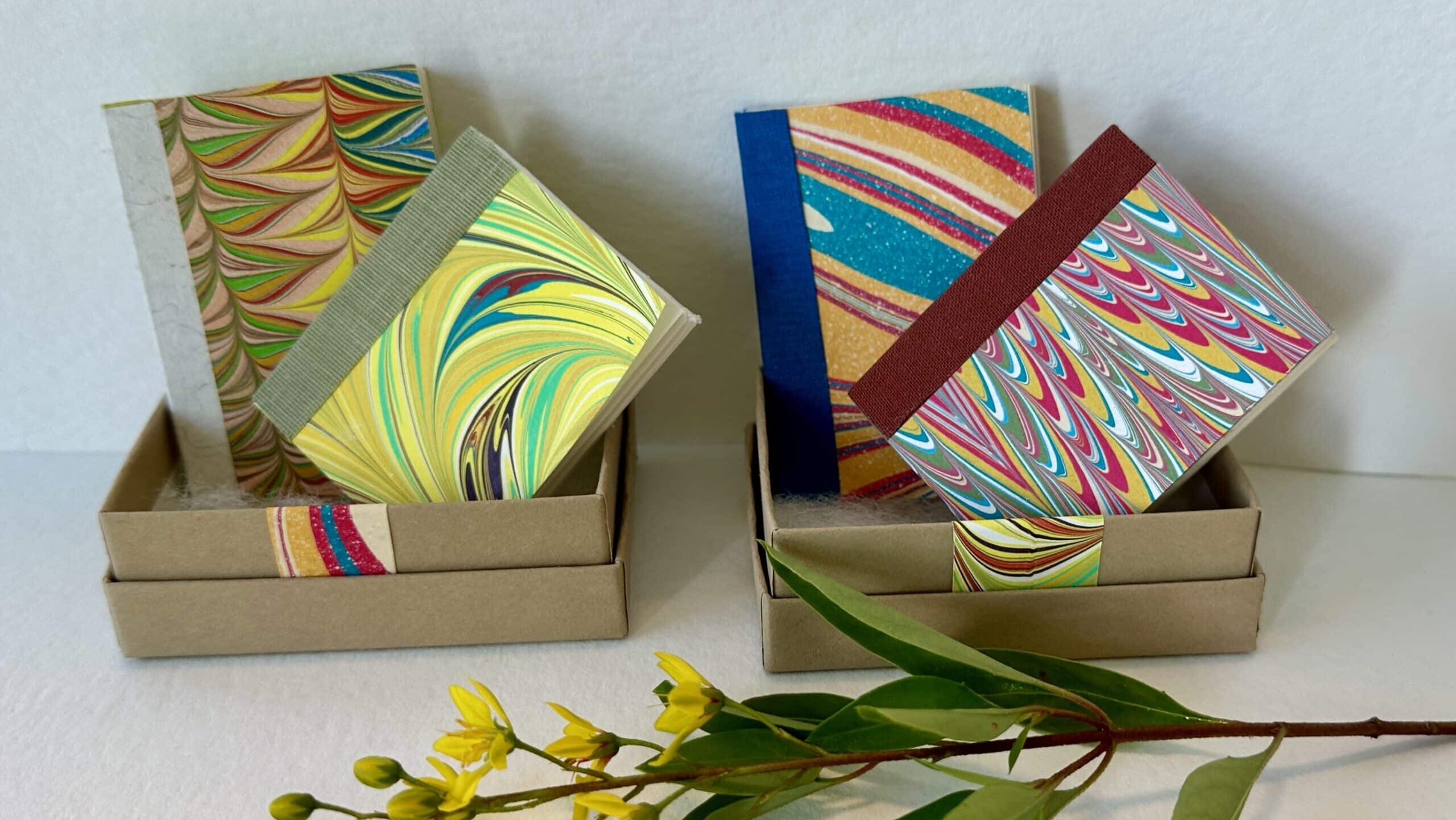 Two boxes holding handmade notebooks.