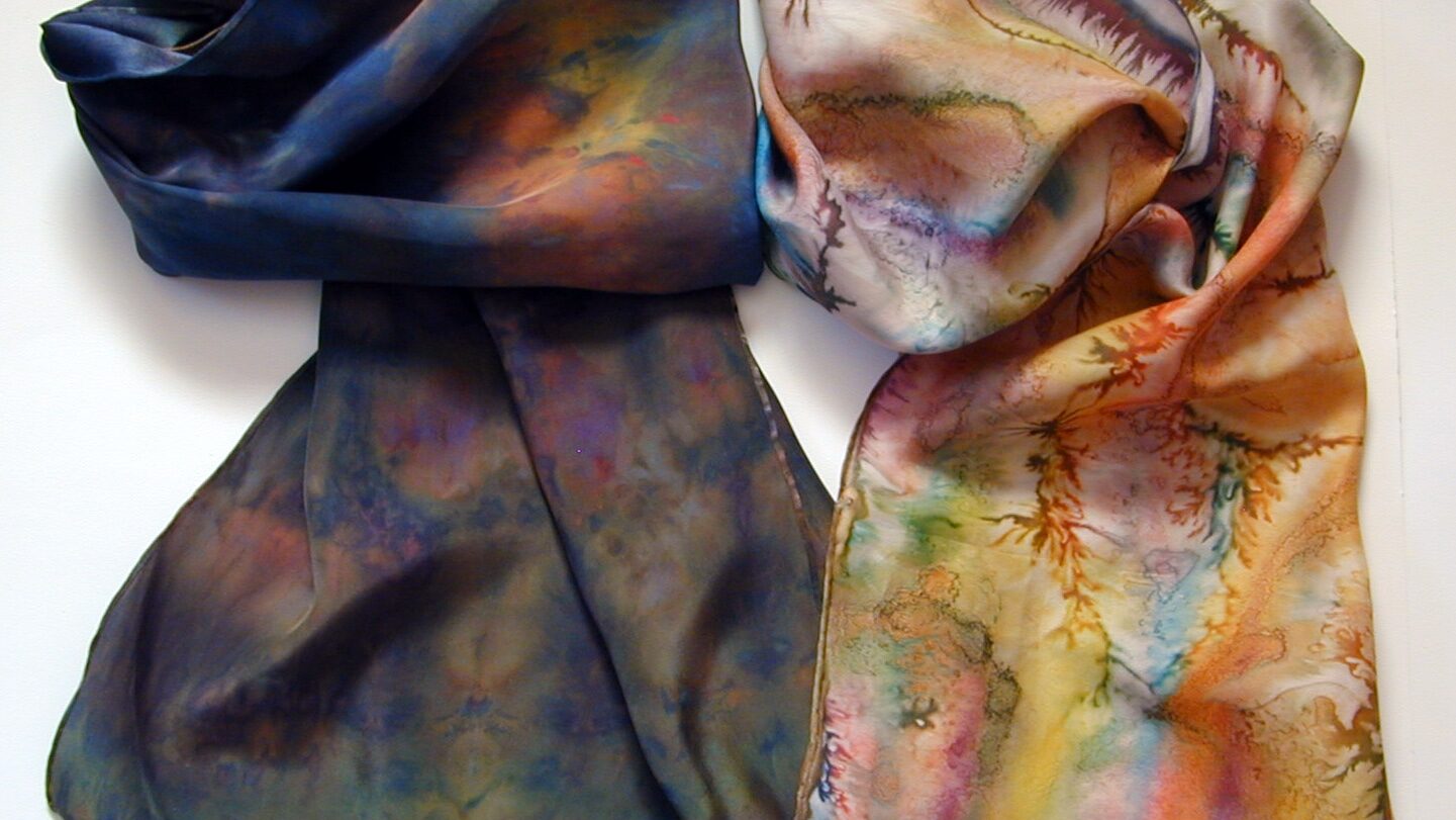 Close up of two colorful handmade scarves